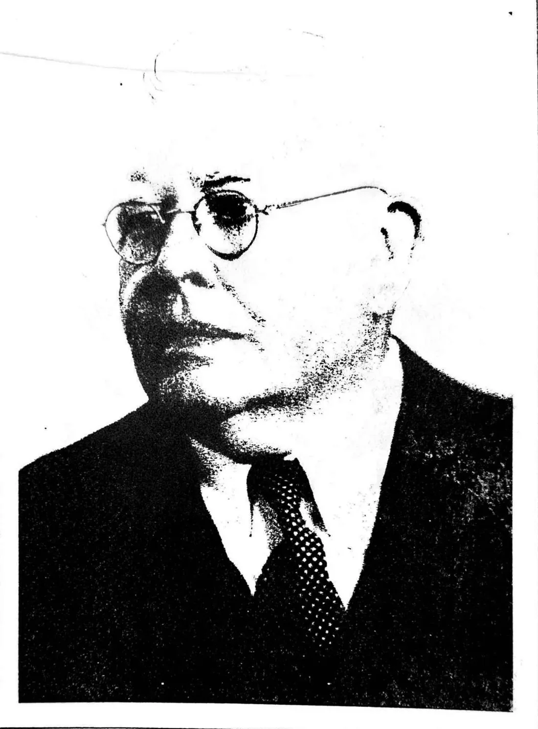 Portrait of Thaddeus McHugh, about 1940, in a suit and round glasses
